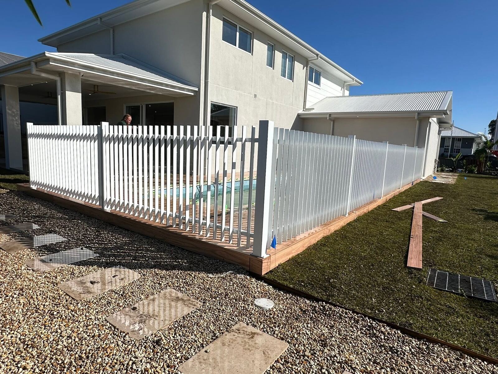 White picket fence along a driveway