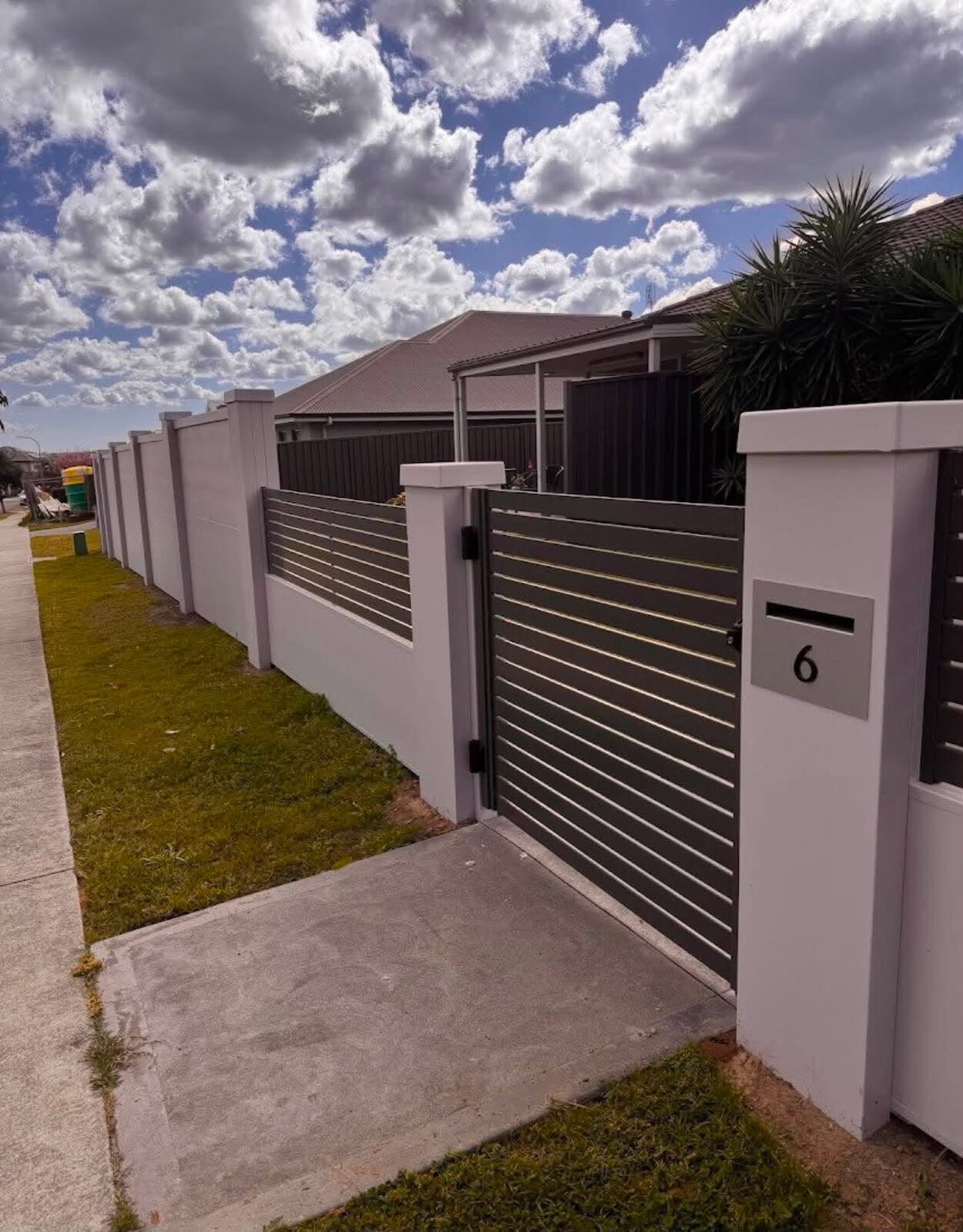 Modular rendered wall and gate with letterbox, close-up view