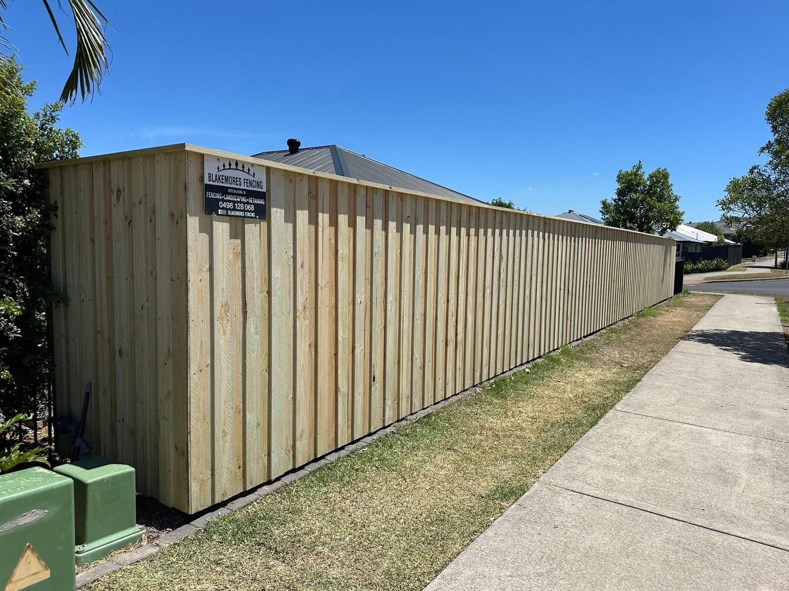 Timber paling fence with Blakemores Fencing sign