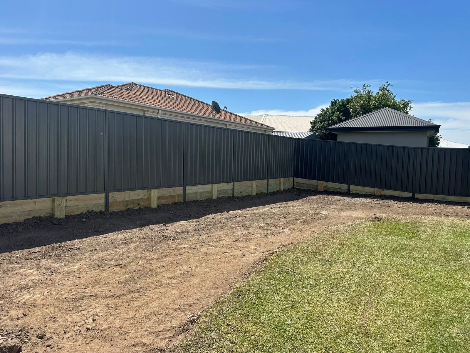 Charcoal Colorbond fence enclosing a backyard
